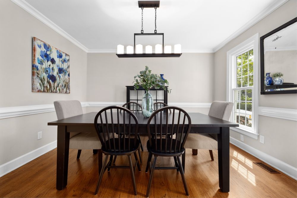 A dining room with an oak floor catching afternoon light in a West End Halifax home.