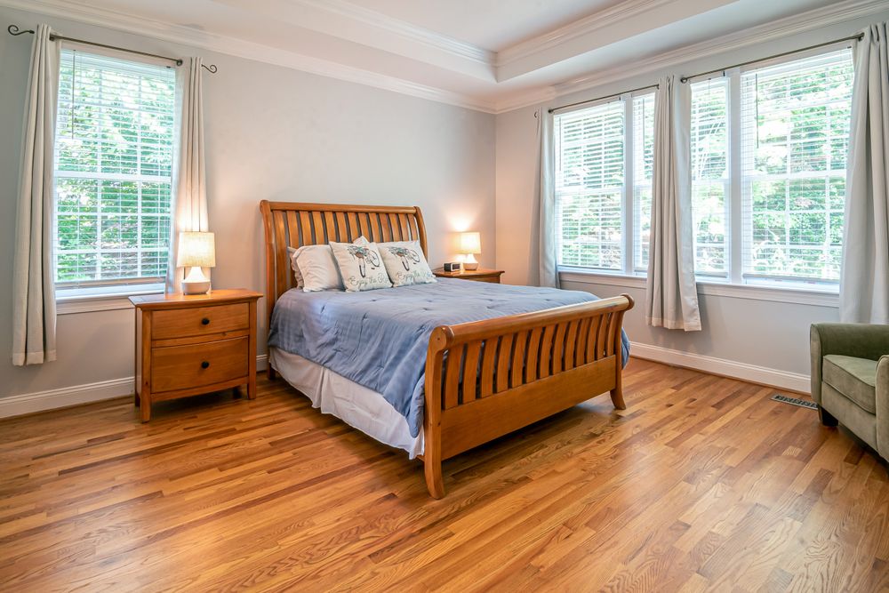 A bedroom with a sound oak floor that only needs a fresh top coat.