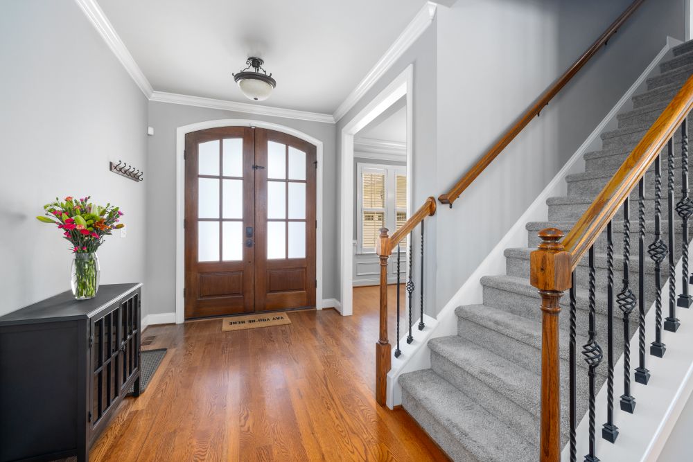 An entry hall with an oak strip floor in a Bedford home.